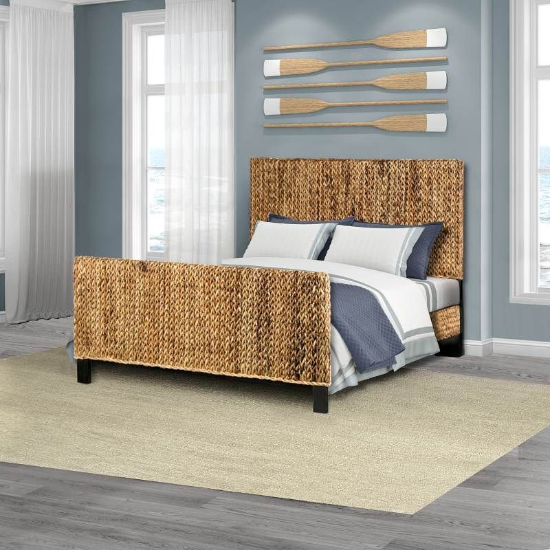 A woven bed with a tropical design, natural finish, available in both queen and king sizes.