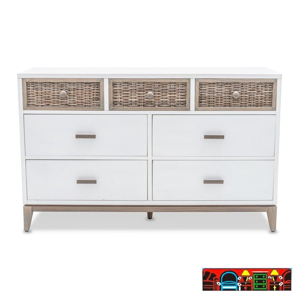 The Kauai Dresser features a coastal design with a white, weathered wash finish, wicker accents and base.