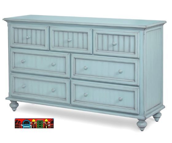 Triple dresser in solid wood, featuring a light blue distressed finish, seven drawers, turned feet, and beadboard accents.