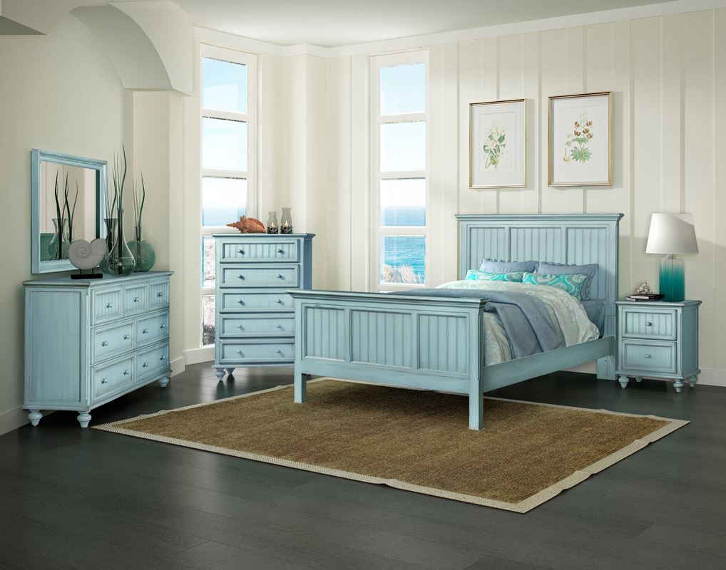 light blue bedroom set with grey accents. Featuring a queen bed, a 2-drawer nightstand, 5-drawer chest, a 7-drawer dresser and mirror. Set-up in a bedroom for display.