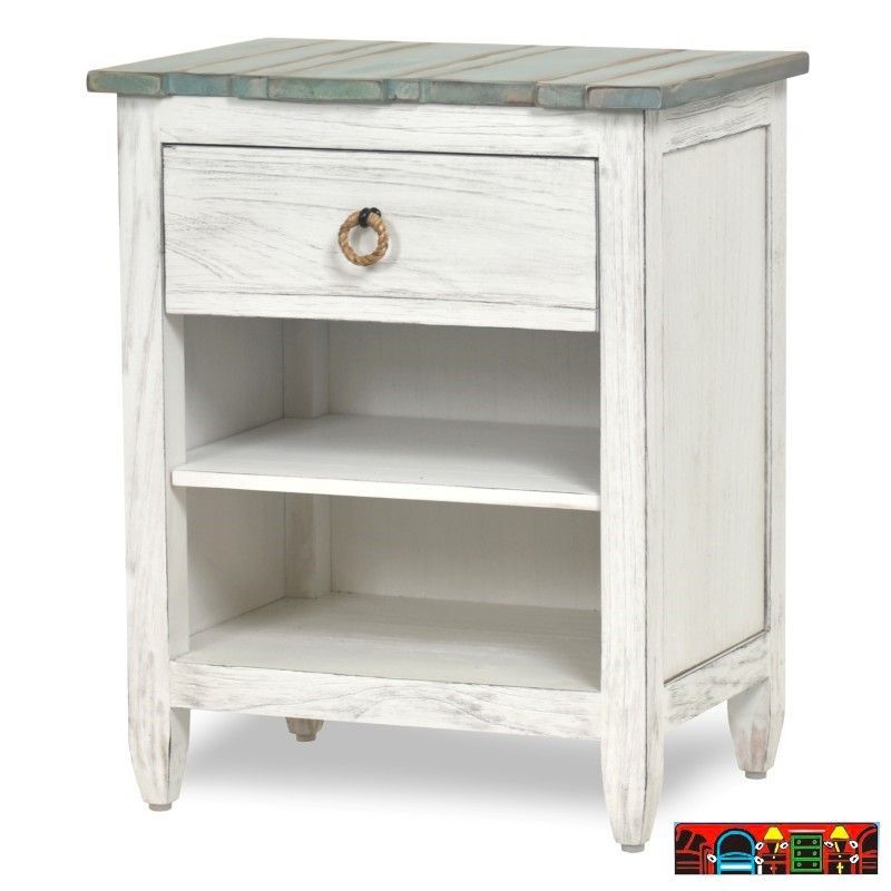 The Picket Fence Bedroom Nightstand offers a coastal charm with its solid wood construction, distressed white finish, weathered blue top, and rope pulls. Available at Bratz-CFW.
