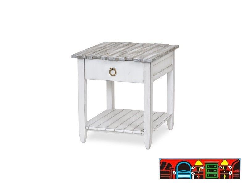 The Picket Fence End Table offers a coastal charm with its solid wood construction, distressed white finish, weathered grey top, and rope pull. Available at Bratz-CFW.