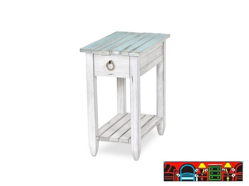 The Picket Fence Chairside Table offers a coastal charm with its solid wood construction, distressed white finish, weathered blue top, and rope pull. Available at Bratz-CFW.