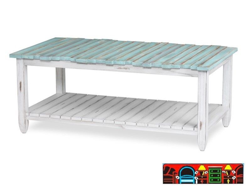 The Picket Fence Coffee Table offers a coastal charm with its solid wood construction, distressed white finish, weathered blue top. Available at Bratz-CFW.