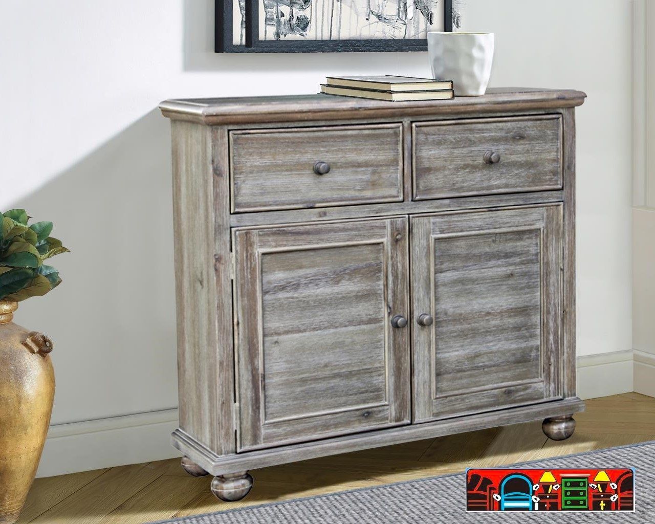 The Studio Ash Cabinet, crafted from wood and finished in a distressed grey. Features Two drawers, two doors, and a shelf. It is available at Bratz-CFW in Fort Myers, FL.
