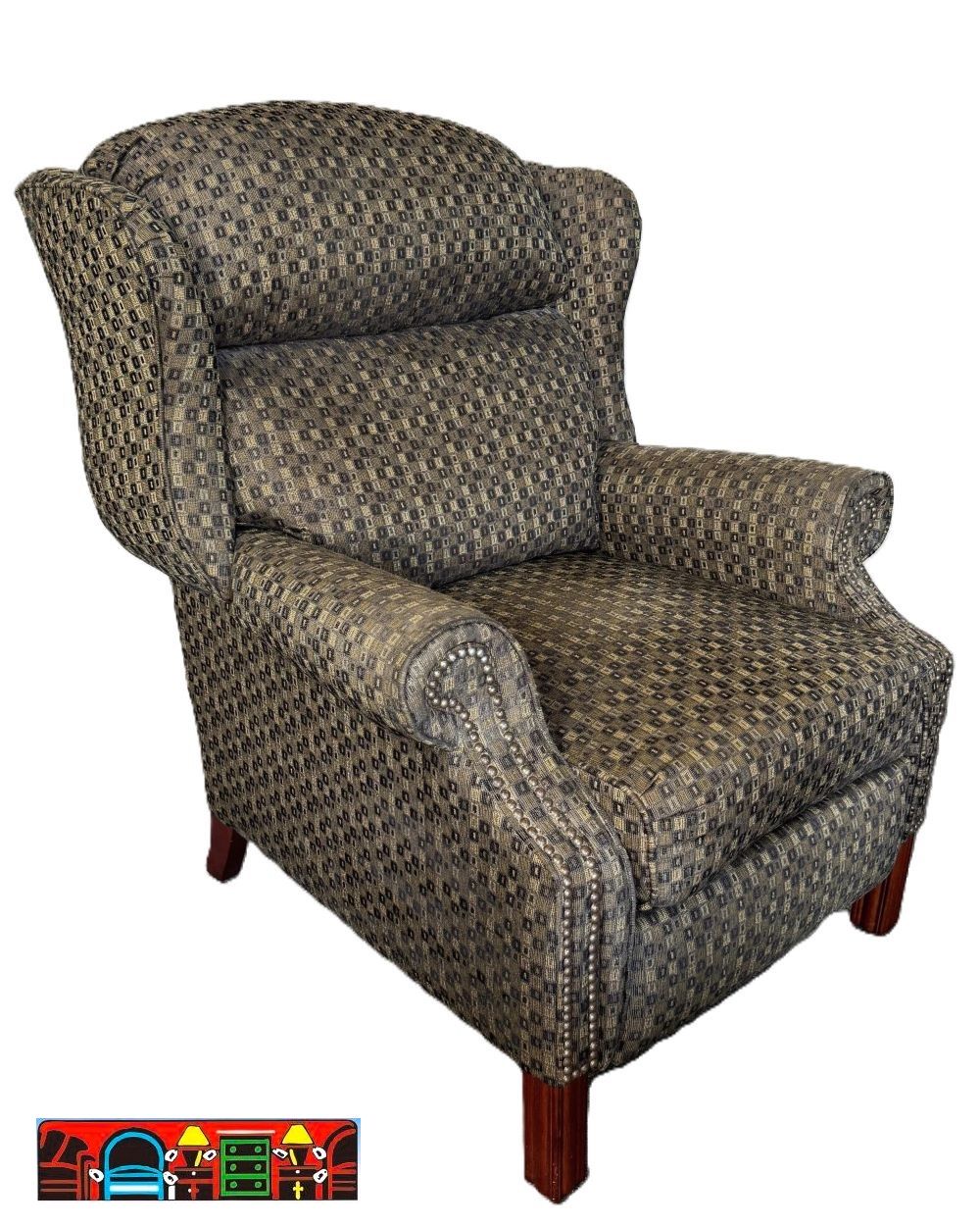'A gently used push-back wing-back recliner featuring rolled arms, exposed wooden legs, and nail head accents, upholstered in a fabric of various shades of grey.'