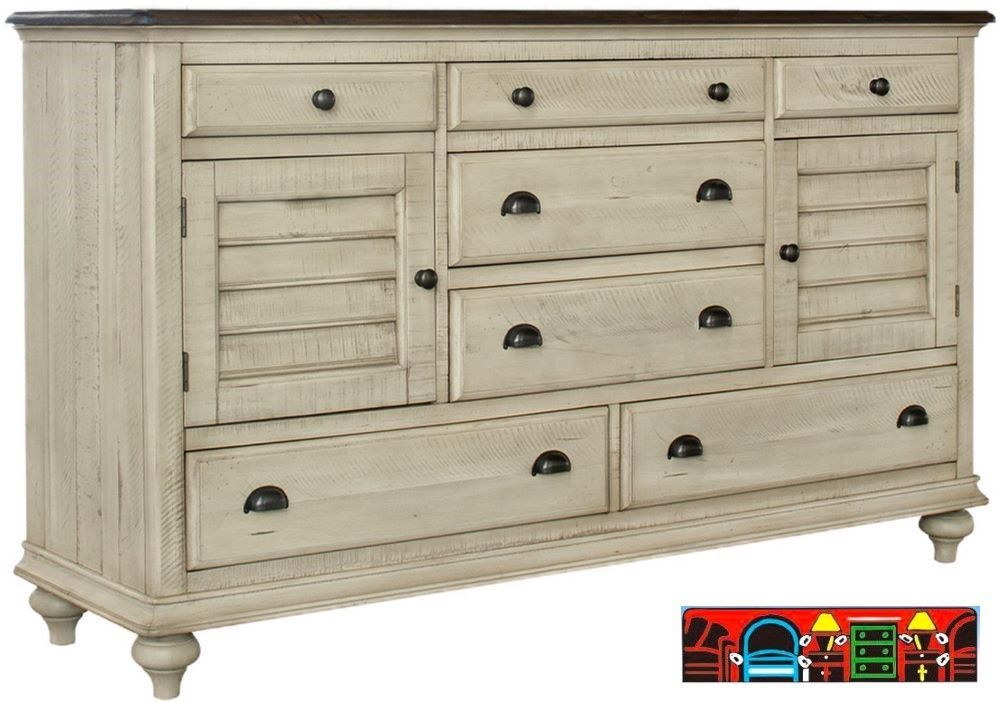 The Brockton Dresser features solid wood construction, a wheat-colored body with a dark brown top, both finished in a distressed style. It includes louver accents, seven drawers, two doors, and contrasting metal handles.