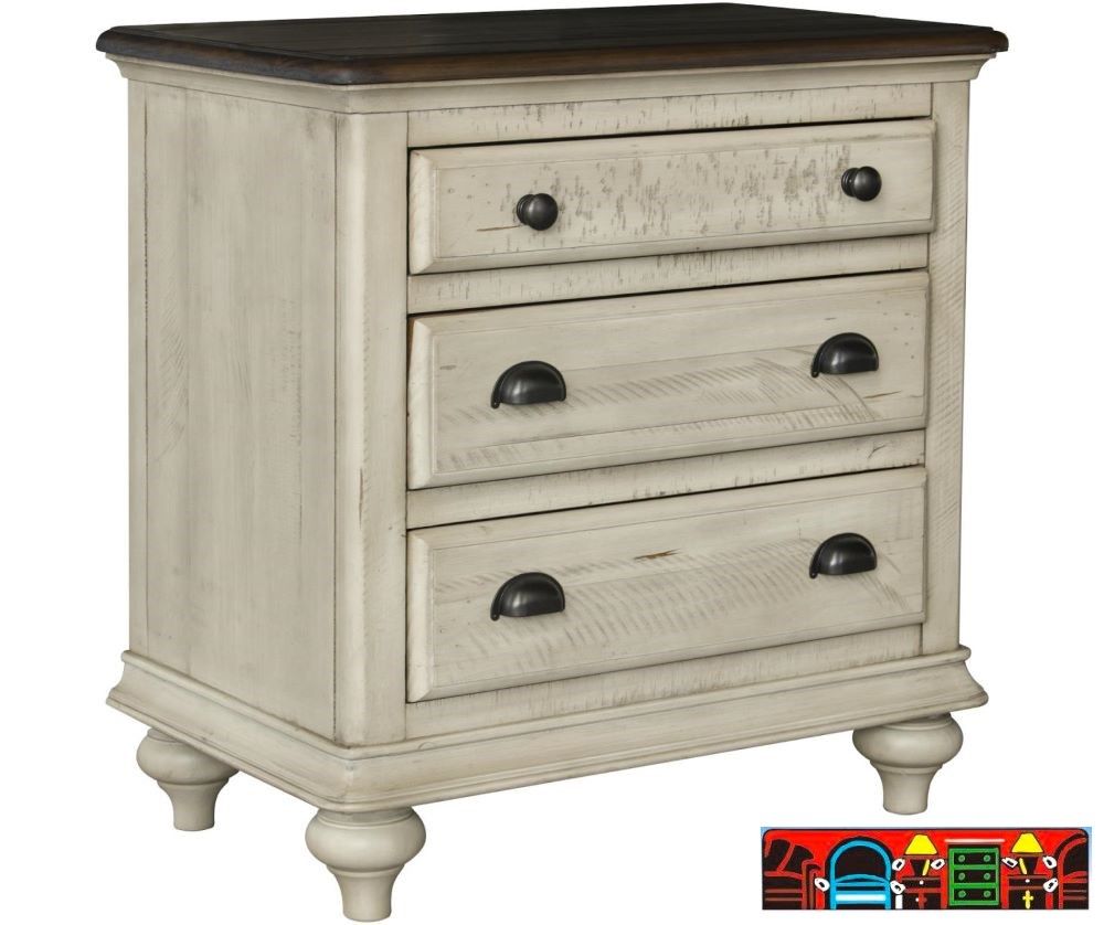 Brockton 3-Drawer Nightstand, crafted from solid wood, features a wheat color with a dark brown top, both exhibiting a distressed finish. It includes louver accents and contrasting metal handles.