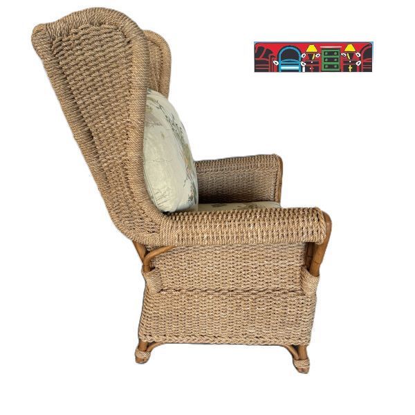 A gently used Wing-Back Chair with a Natural Woven & Rattan Frame including Reversible Cushions Featuring a Tropical Design.