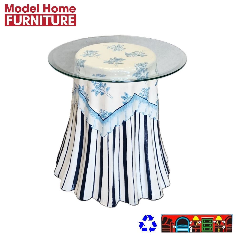 An accent end table designed to resemble fabric, featuring white with blue flowers on top and dark blue and white stripes on the bottom, is available at Bratz-CFW in Fort Myers, FL.