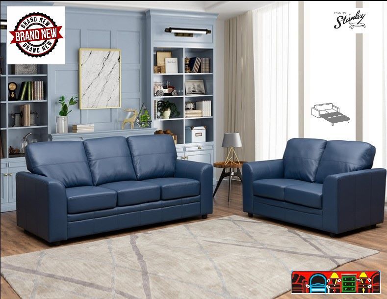 A dark blue leather queen-sized sofa bed that has straight sides and a matching Loveseat.