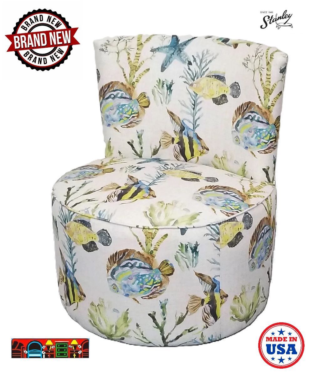 'A coastal slipper chair featuring a light beige background adorned with patterns of yellow, blue, and green fish, seaweed, and starfish. Proudly made in the USA!'