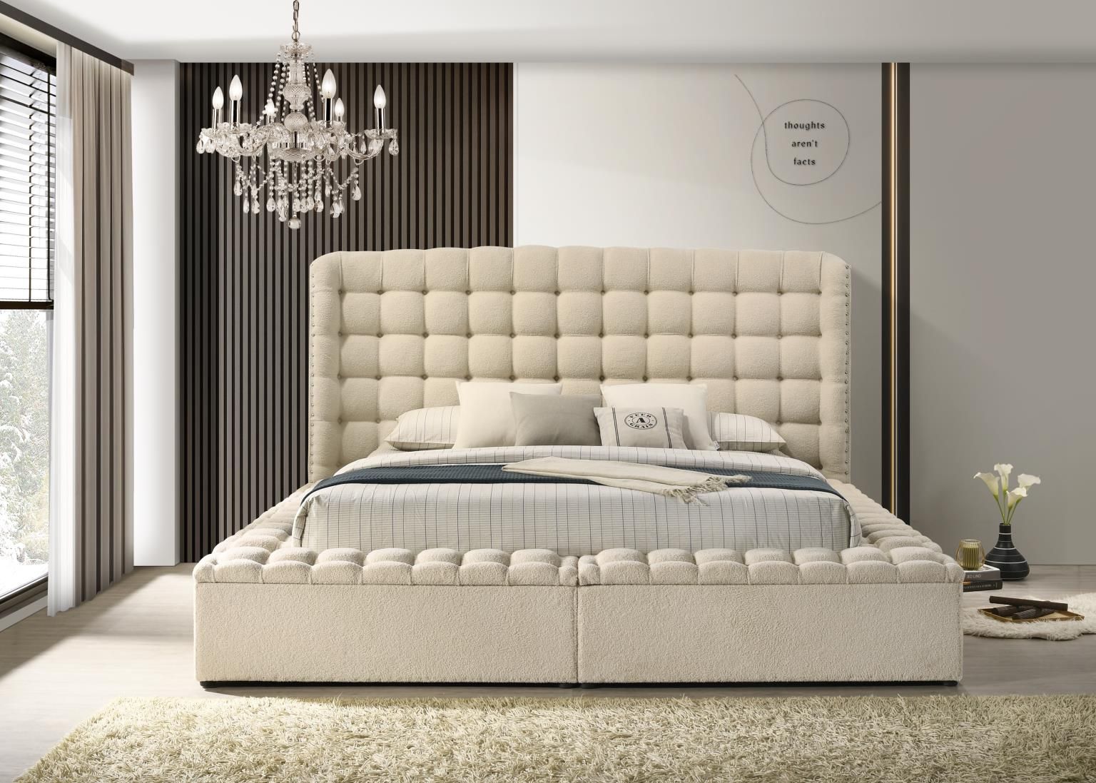 Beige completely upholstered storage bed with high headboard, tufted surround and nail head accents.