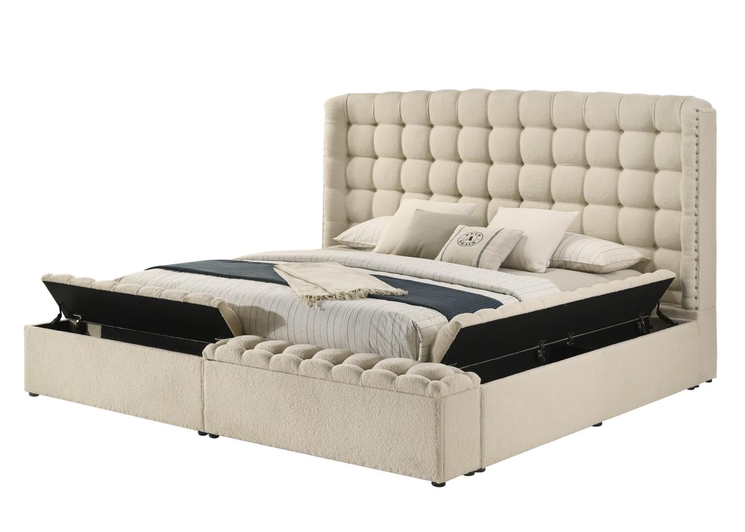Beige completely upholstered storage bed with high headboard, tufted surround and nail head accents.