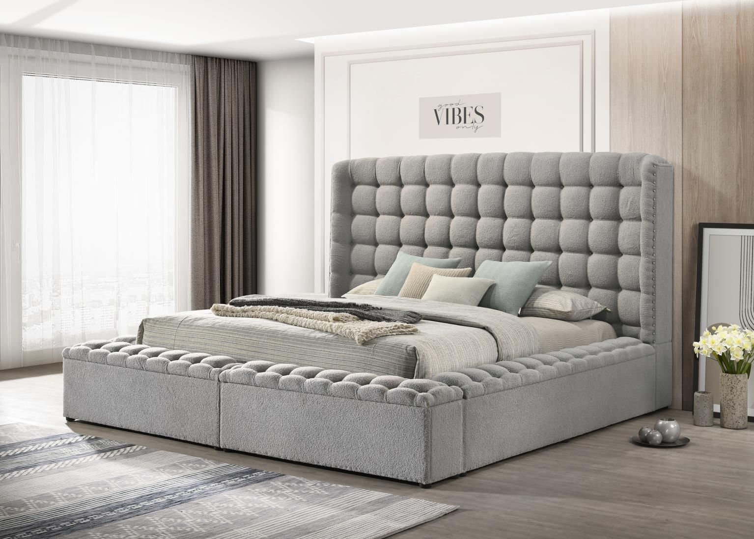 Grey completely upholstered storage bed with high headboard, tufted surround and nail head accents.