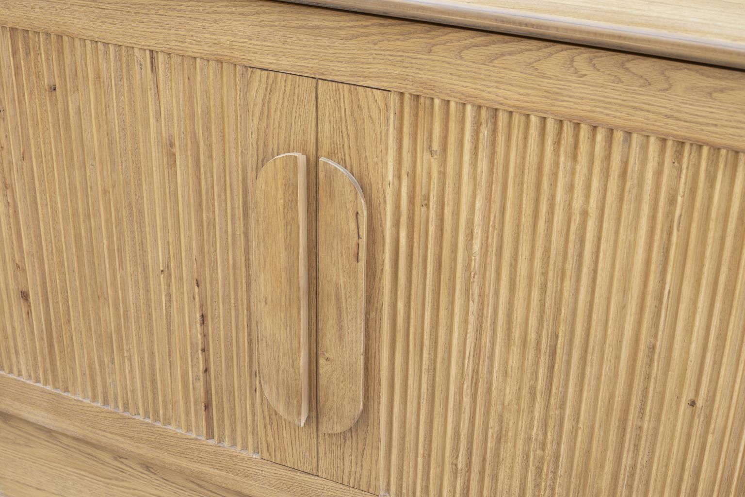 Oak finish cabinet bed with a decorative pencil wood design and 2 large wood handles. with a drawer at the bottom. Close-up view of the front panel & decorative handles.