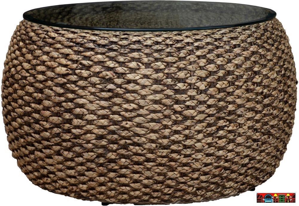 The Ocean Reef round coffee table, featuring woven seagrass in a natural color and a glass top, is available at Bratz-CFW in Fort Myers, FL.