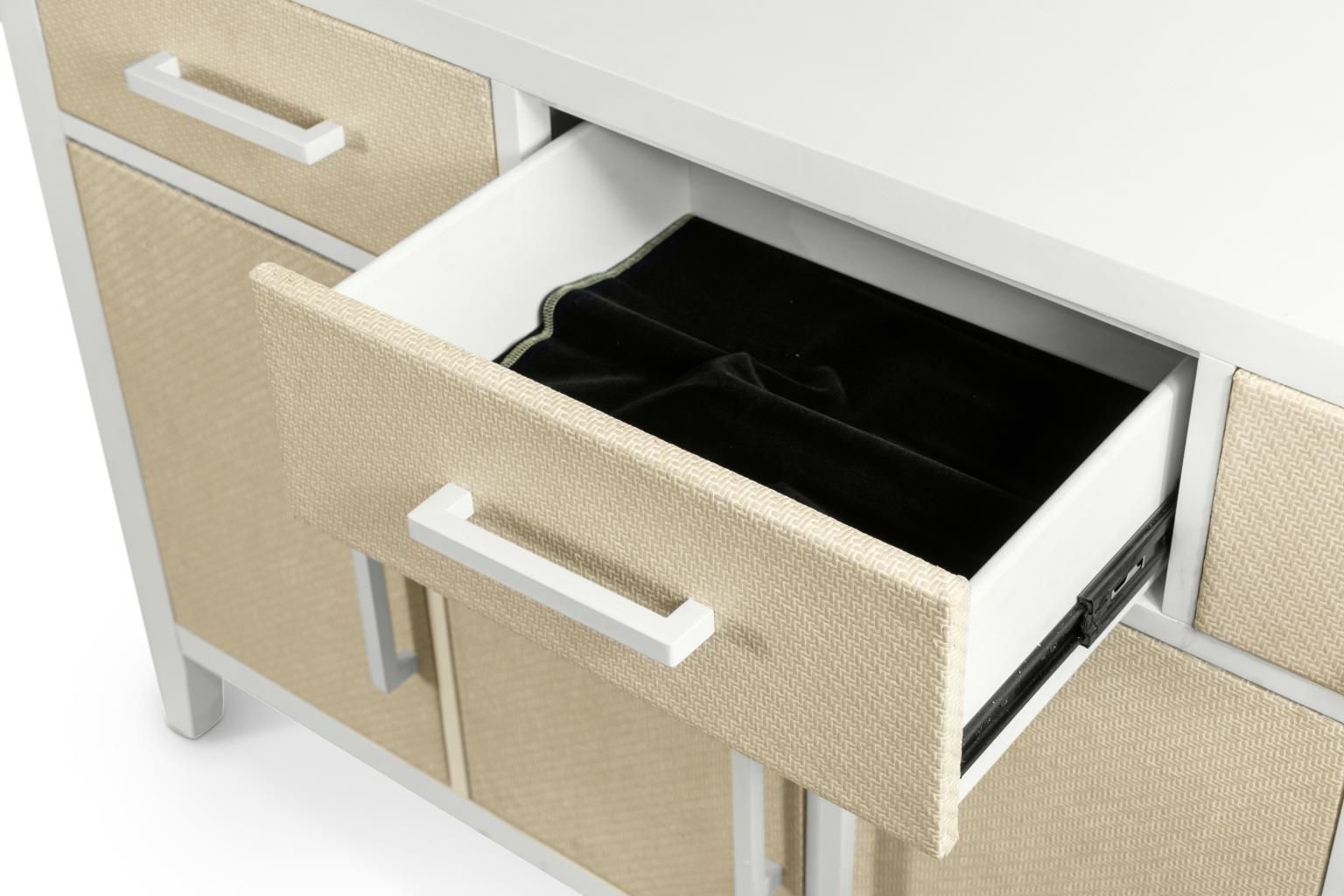  Credenza with 3 drawers on top of 4 doors. White wood with woven sand color accents and white metal handles. Pictured with the center drawer open. Featuring a lined silverware holder.