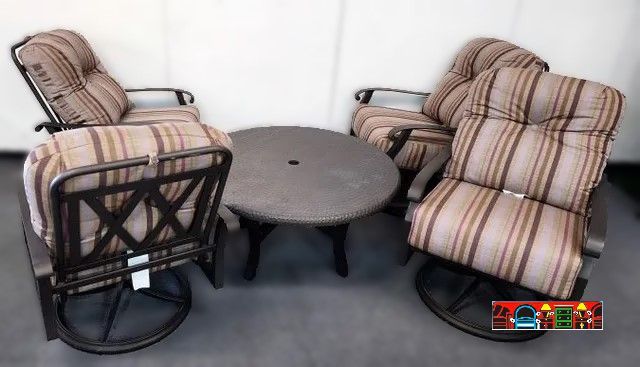 4 swivel rocking outdoor chairs with plush striped cushions and hammered round cocktail table