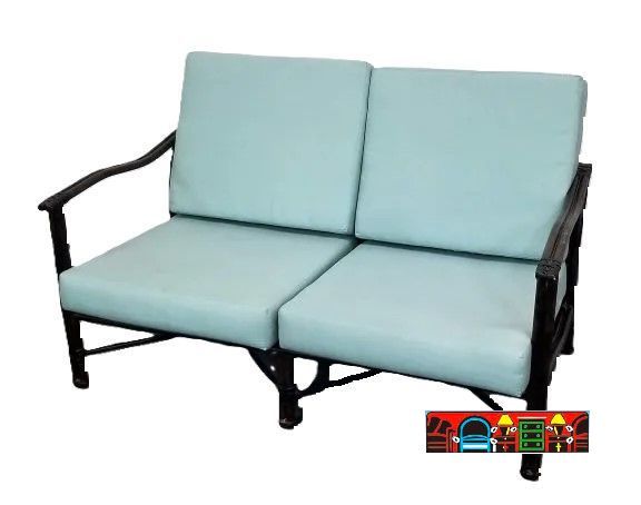 A plush teal cushioned loveseat made of cast aluminum with a dark brown finish for outdoor use.