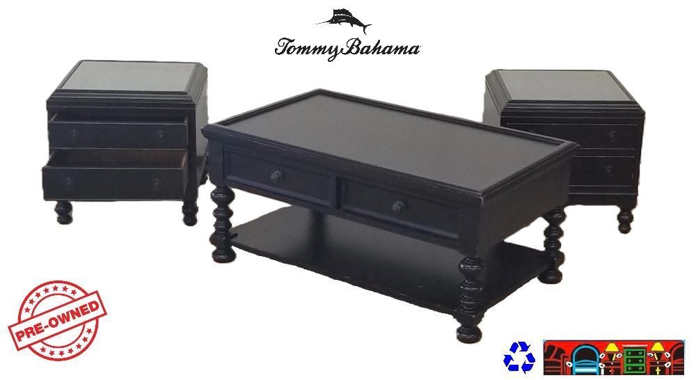 Tommy Bahama occasional tables are crafted from mahogany solids, complemented by American maple and mahogany veneers. They feature solid brass hardware, two drawers, and one shelf. The surfaces are intentionally distressed to add character, and they are finished in a rich tamarind tone.