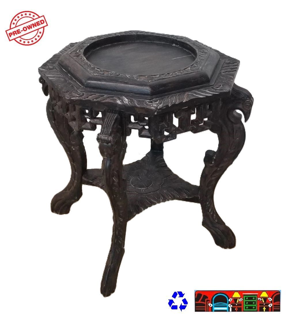 A black carved wood plant stand is available at Bratz-CFW in Fort Myers, FL.