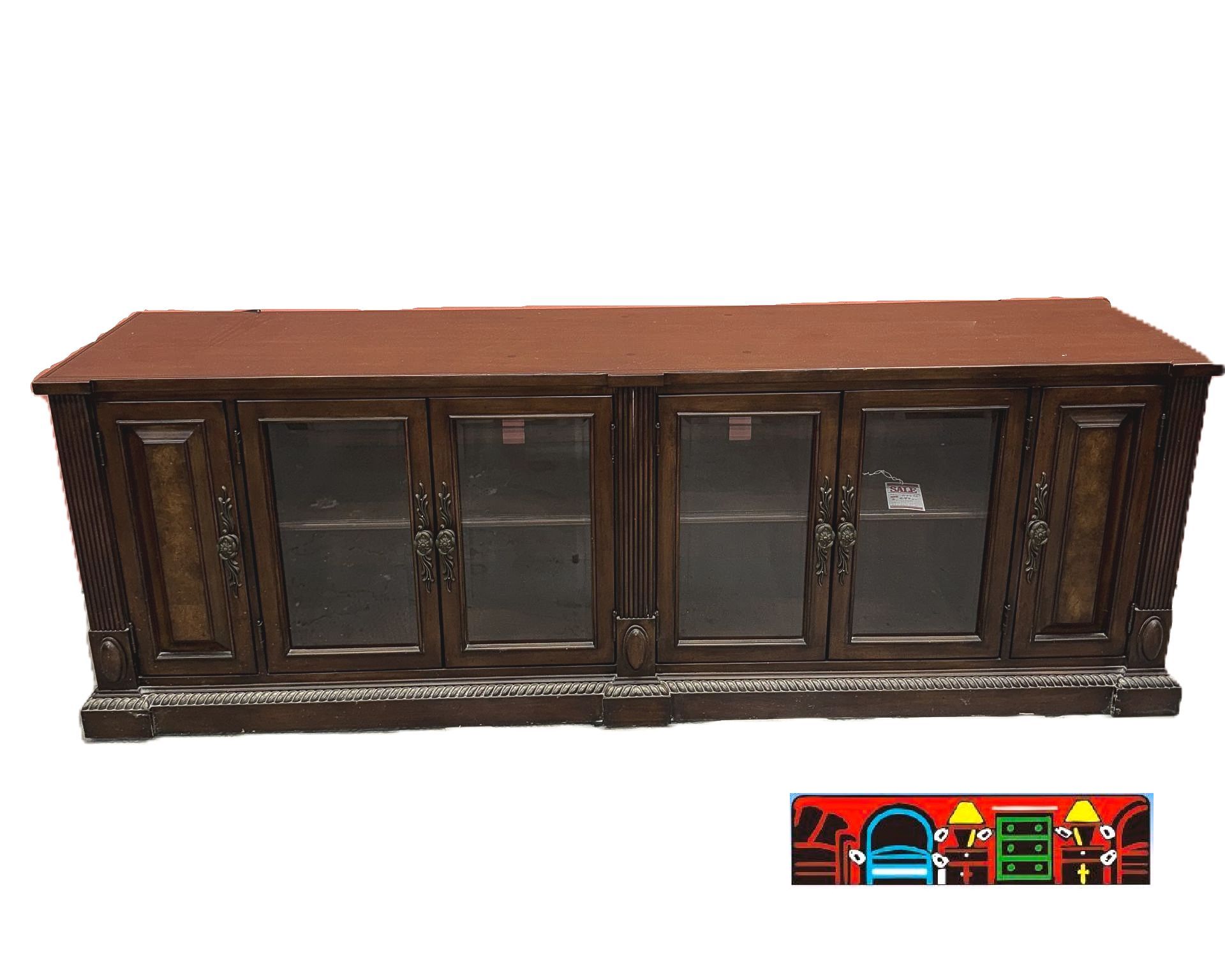 This entertainment console is made of dark brown wood and has six doors in total. Four of them have glass fronts and two have a wooden front. Each door conceals a shelf behind it.