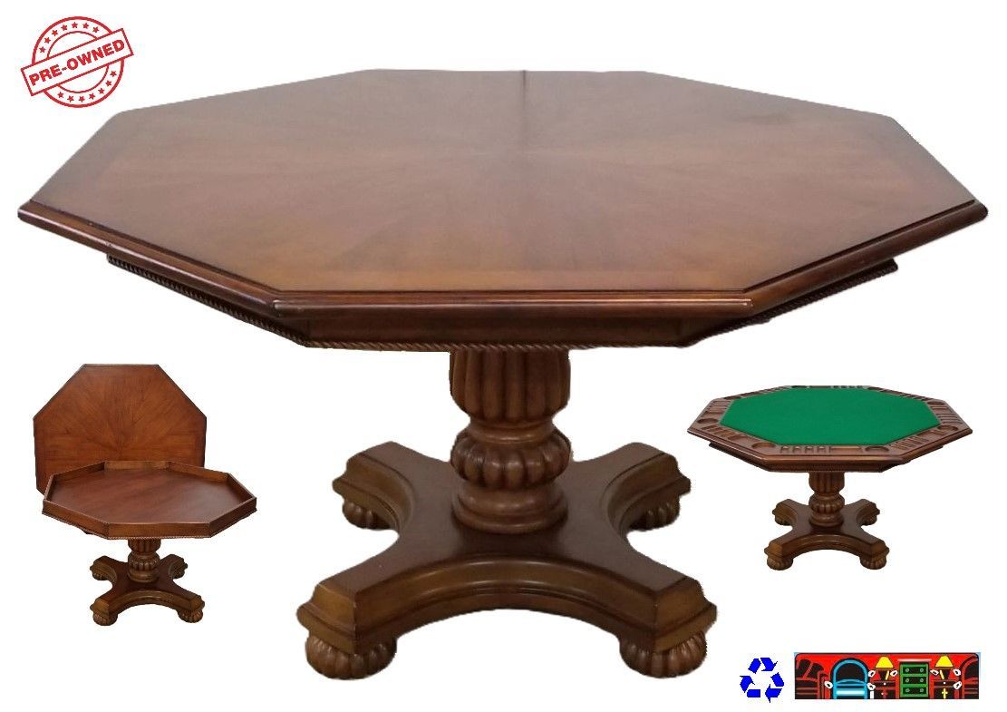 This is a medium brown game table made of solid wood. It has an octagonal top and a pedestal base. It comes with three different surfaces that can be switched easily. One surface is plain wood, another is green felt with drink holders and chip slots for poker, and the last one is solid wood indented for dice or other games.