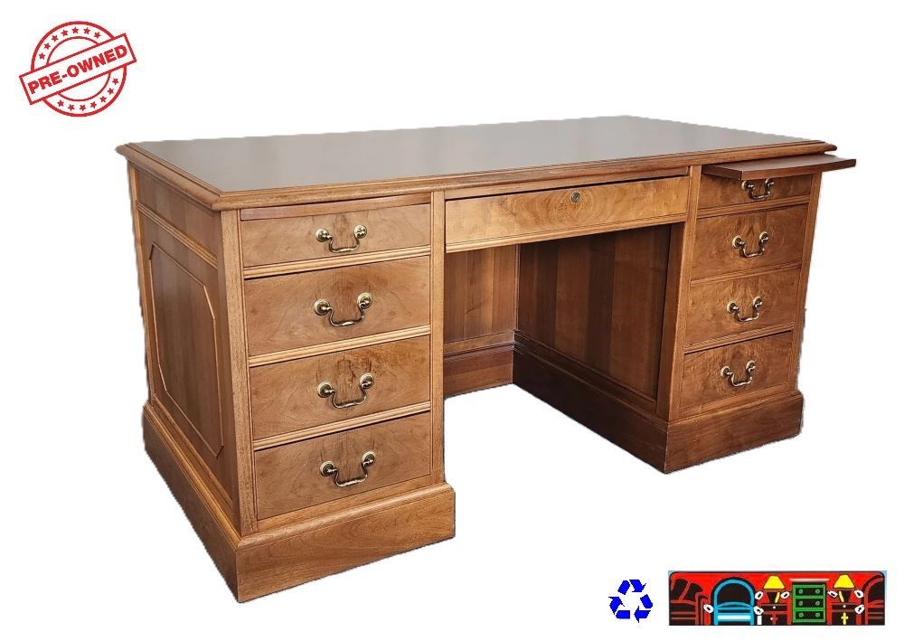 Solid wood light brown small executive desk. Has 1 file drawer multiple storage drawers, 2 document treys and key.