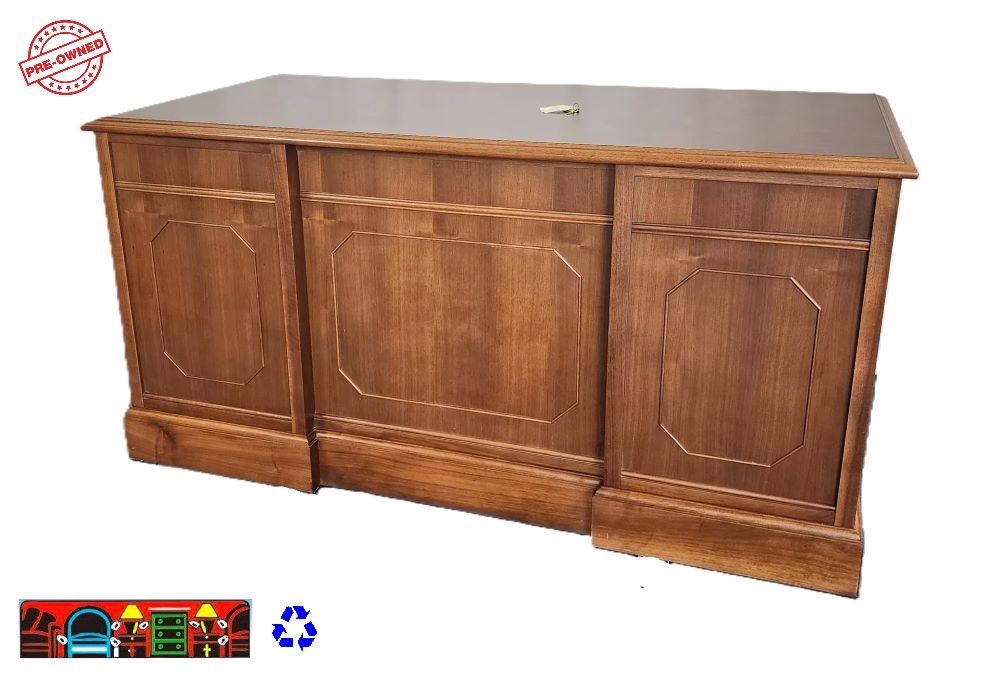 Solid wood light brown small executive desk. Has 1 file drawer multiple storage drawers, 2 document treys and key.