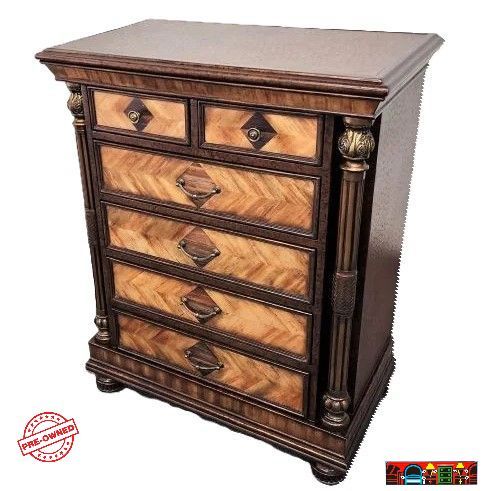 Accent 5-drawer chest, crafted from wood with herringbone-patterned drawer fronts and encased in brown leather, featuring column accents, is available at Bratz-CFW in Fort Myers, FL.
