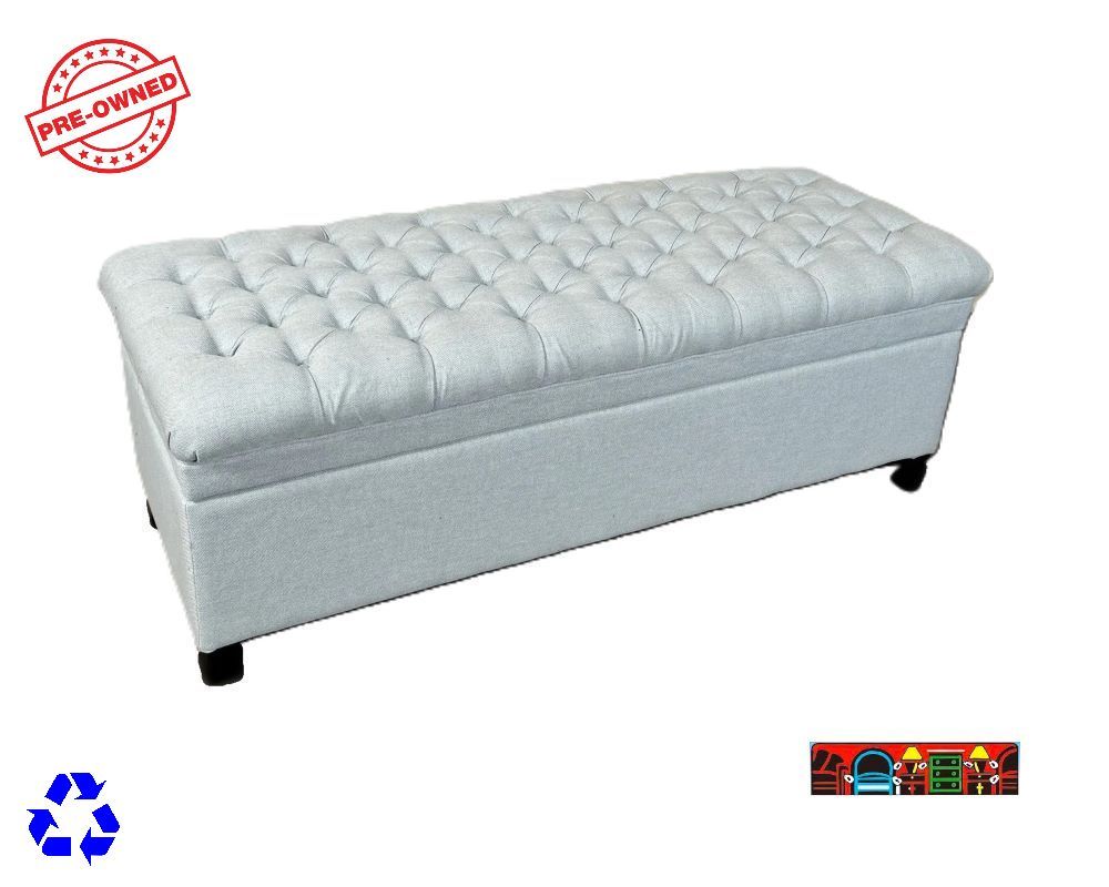 A storage trunk covered in light blue fabric with a tufted top is available at Bratz-CFW in Fort Myers, FL.