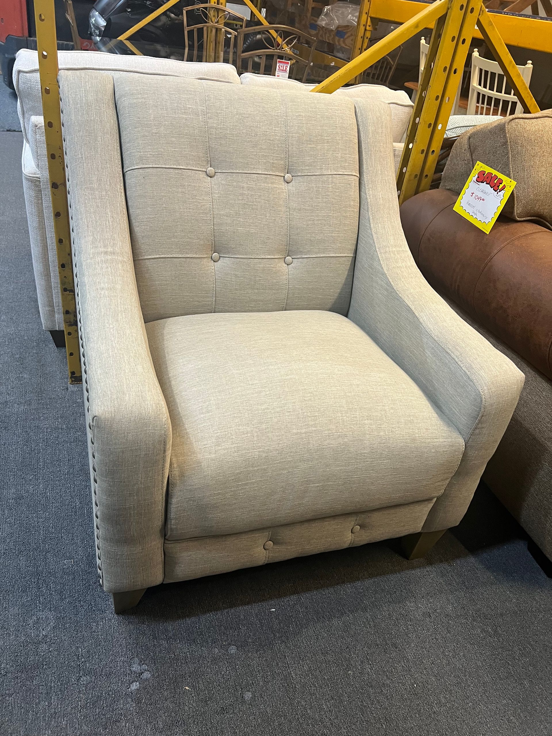 Light grey accent chair with nailhead trim