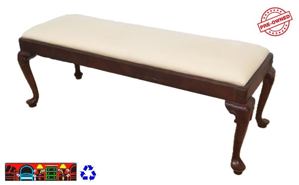 A Queen Anne style bench with a wooden frame and cream-colored cushion is available at Bratz-CFW in Fort Myers, FL.