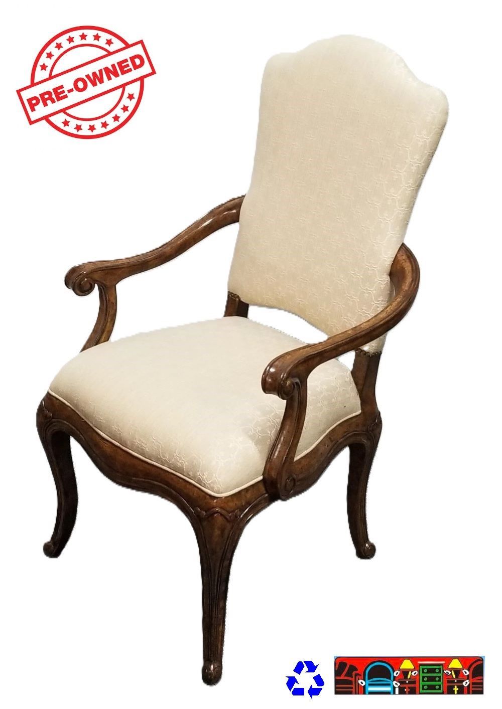 'A gently used accent chair in medium brown, featuring an exposed wood frame with detailed craftsmanship, and eggshell-colored upholstery with a faint print on both the tight back and seat.'