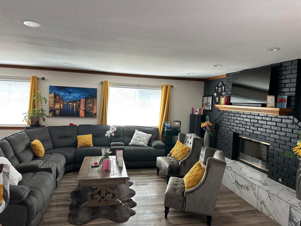 A living room filled with furniture and a fireplace.