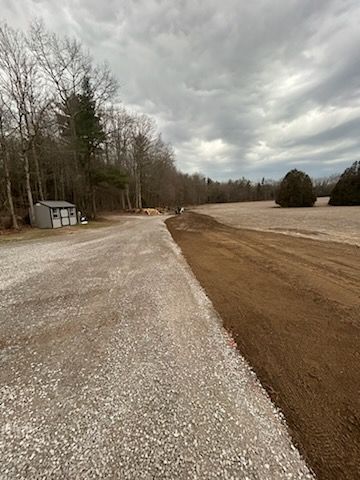 New gravel driveway completed with excavator.