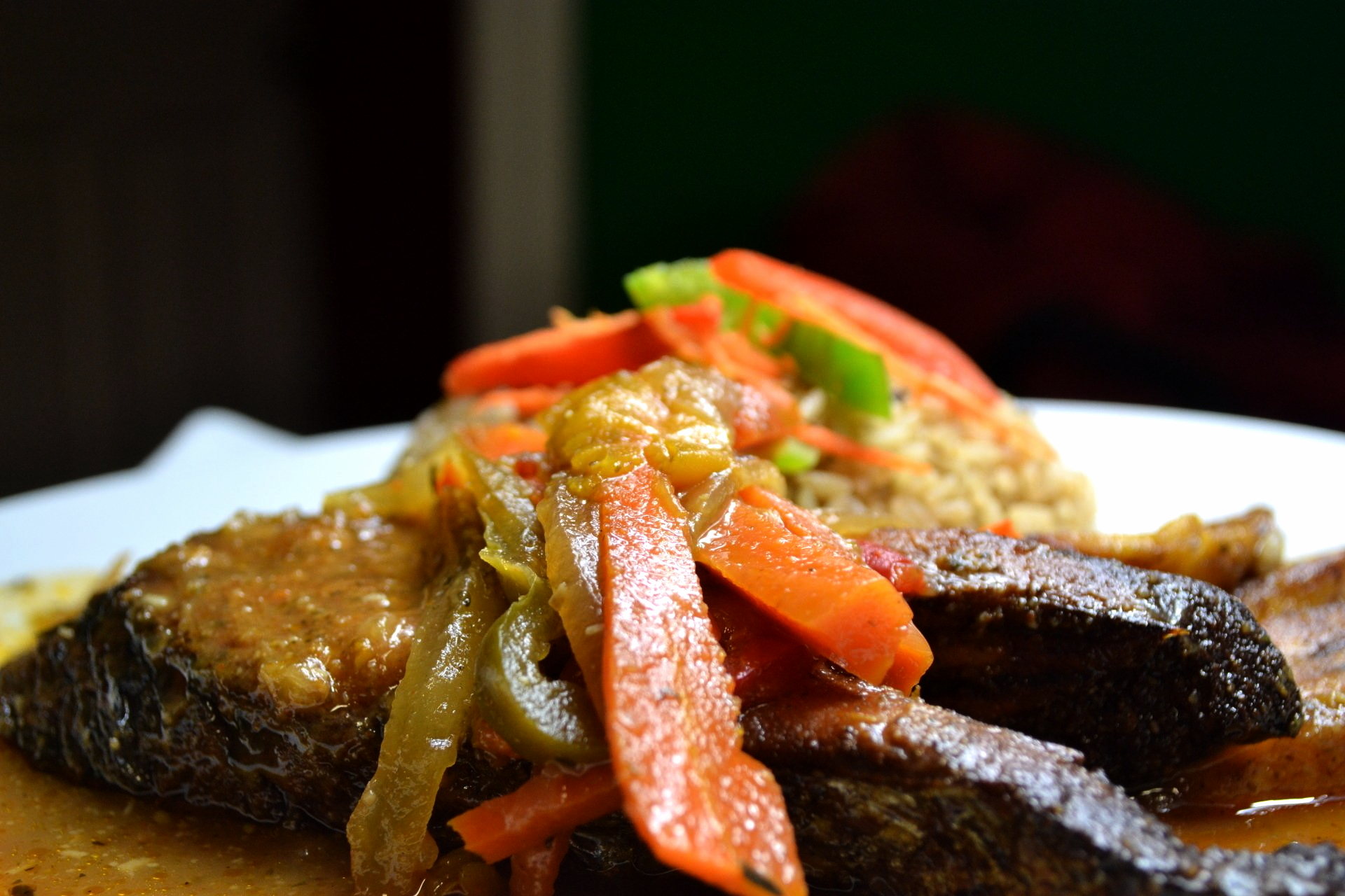 A close up of a plate of food with Kingfish and vegetables