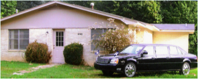 White building with black car in front of it