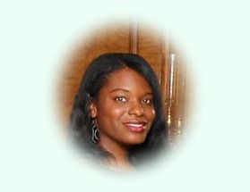 Smiling woman with dark hair and earrings, against a blurred background.