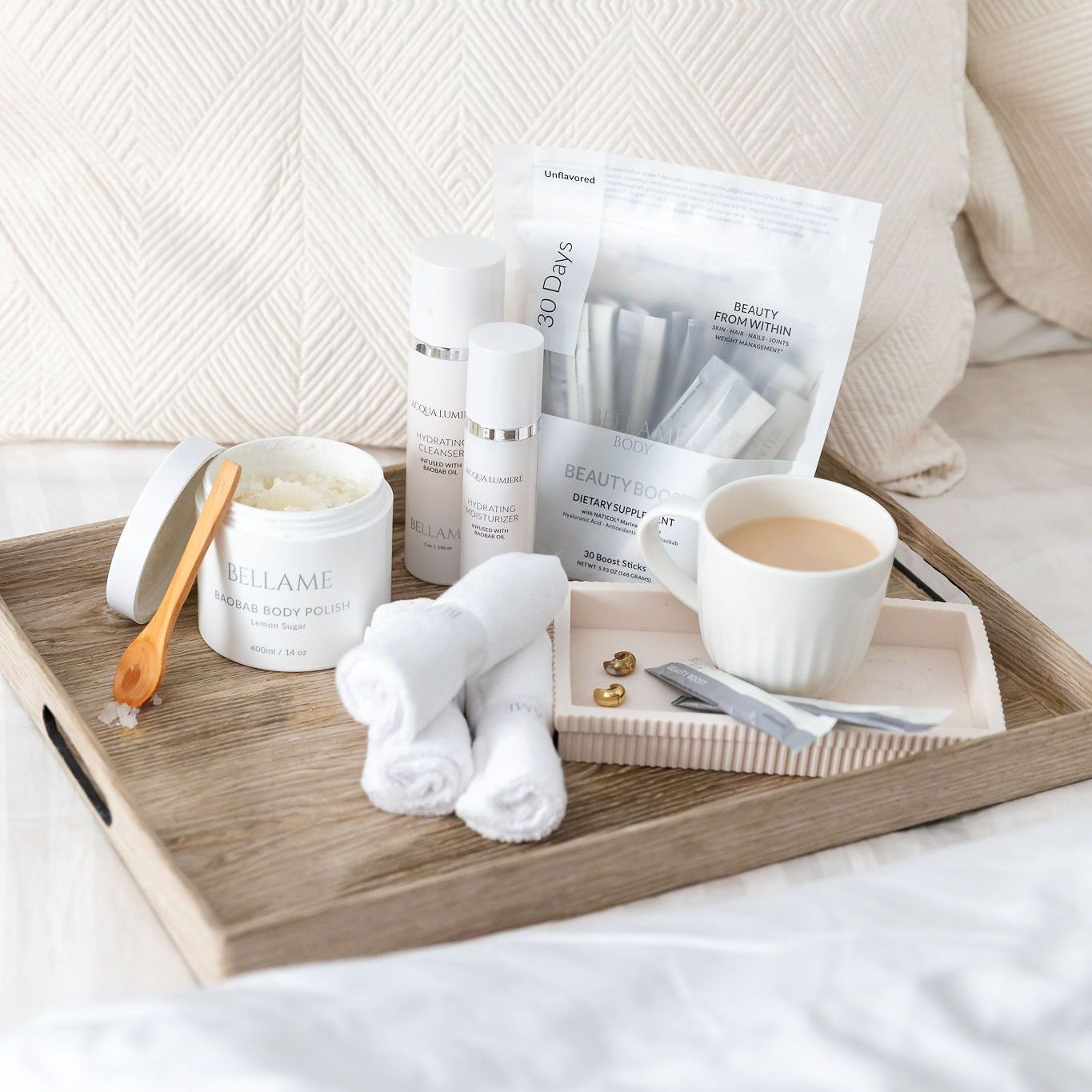 a wooden tray filled with a variety of skin care items including and a cup of coffee
