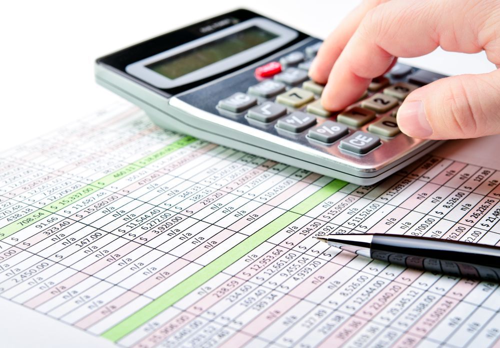 A Person Is Using A Calculator On A Sheet Of Paper — One Stop Bookkeeping in Lennox Head, NSW