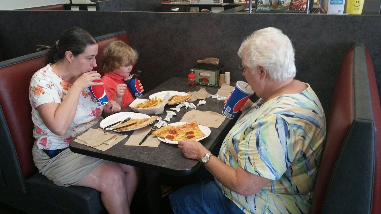 multi-generation family enjoying some pizza