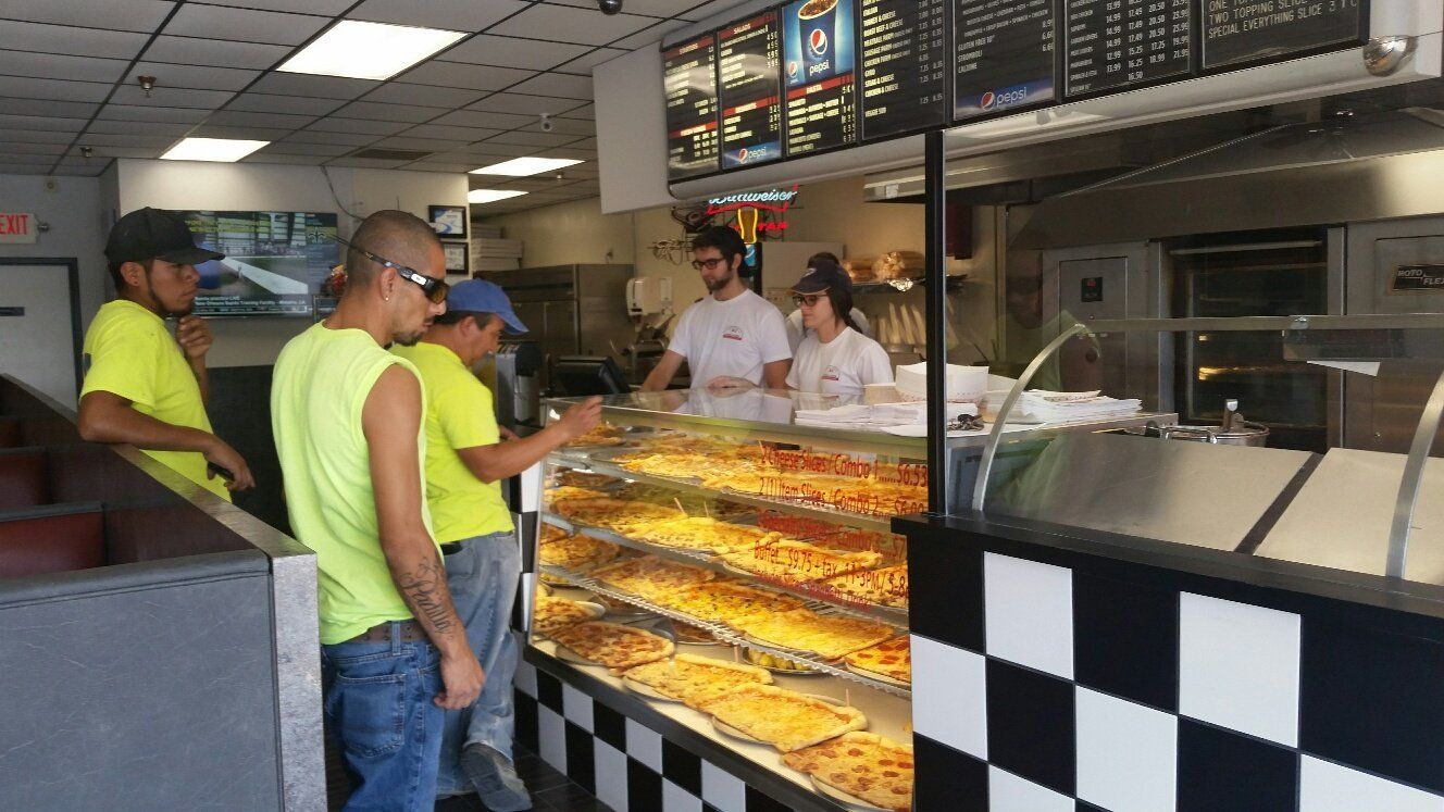 customers placing pizza order at front counter