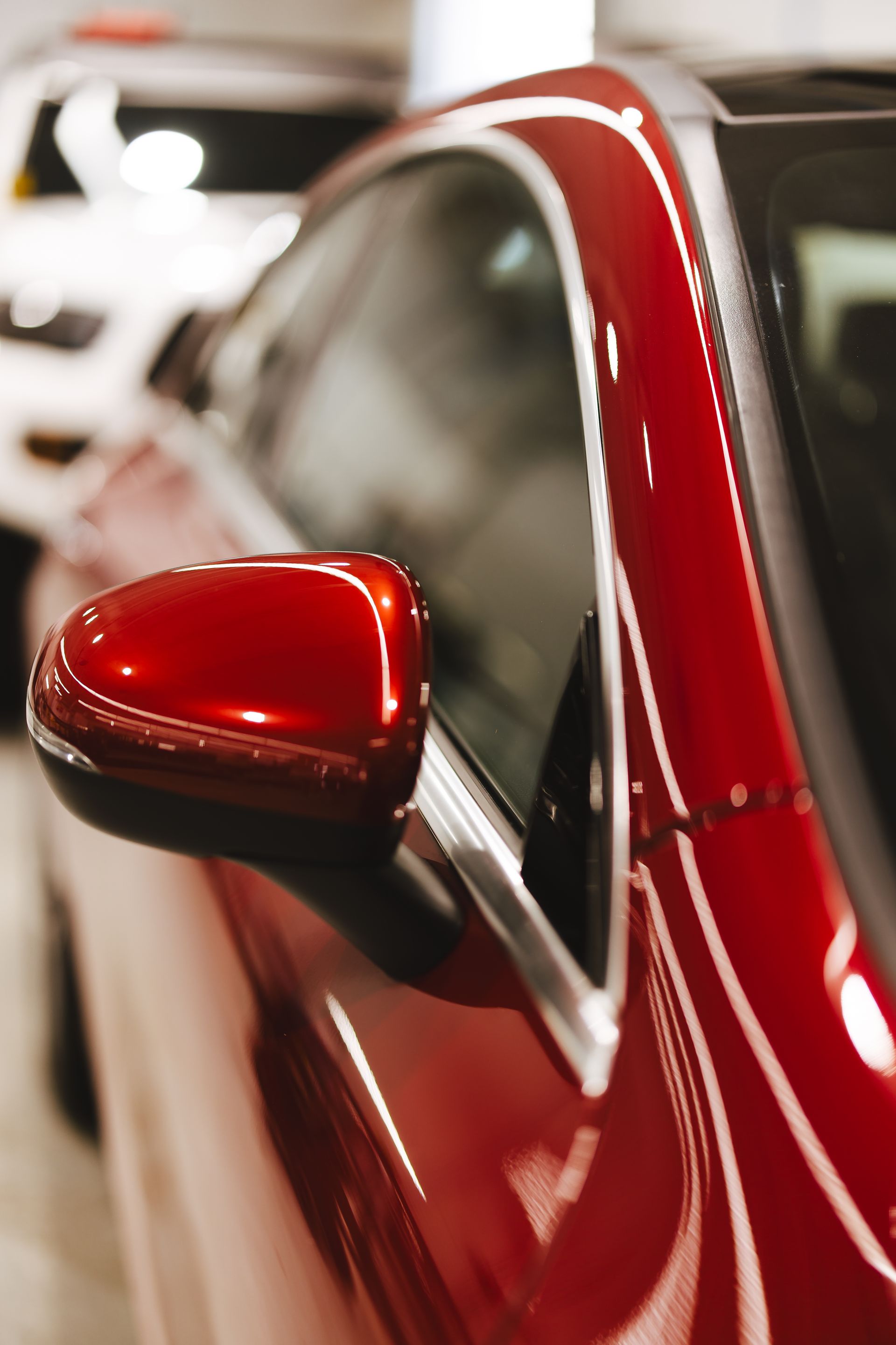 A person is cleaning the hood of a car with a cloth.