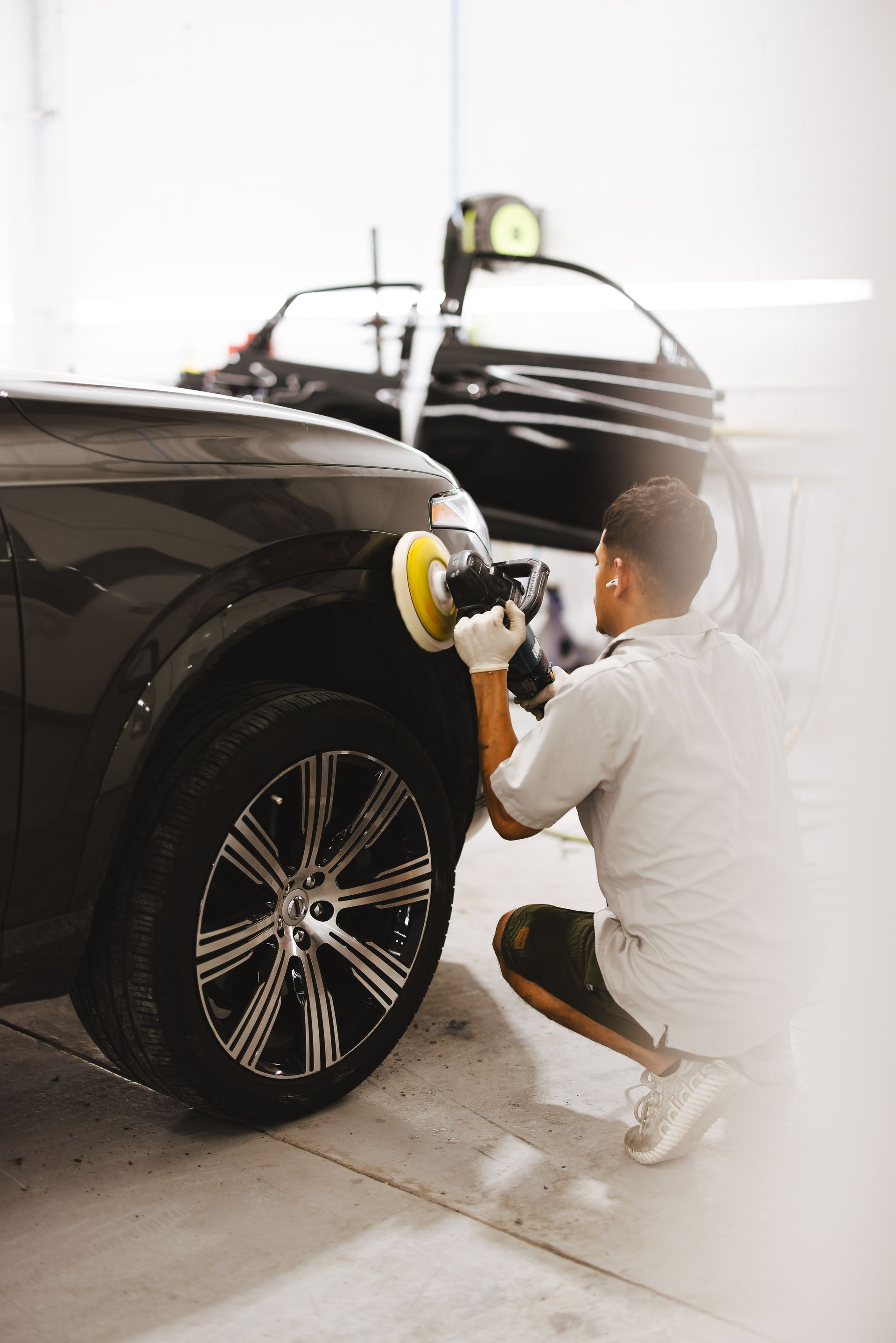 A black ford mustang is parked in a parking lot.