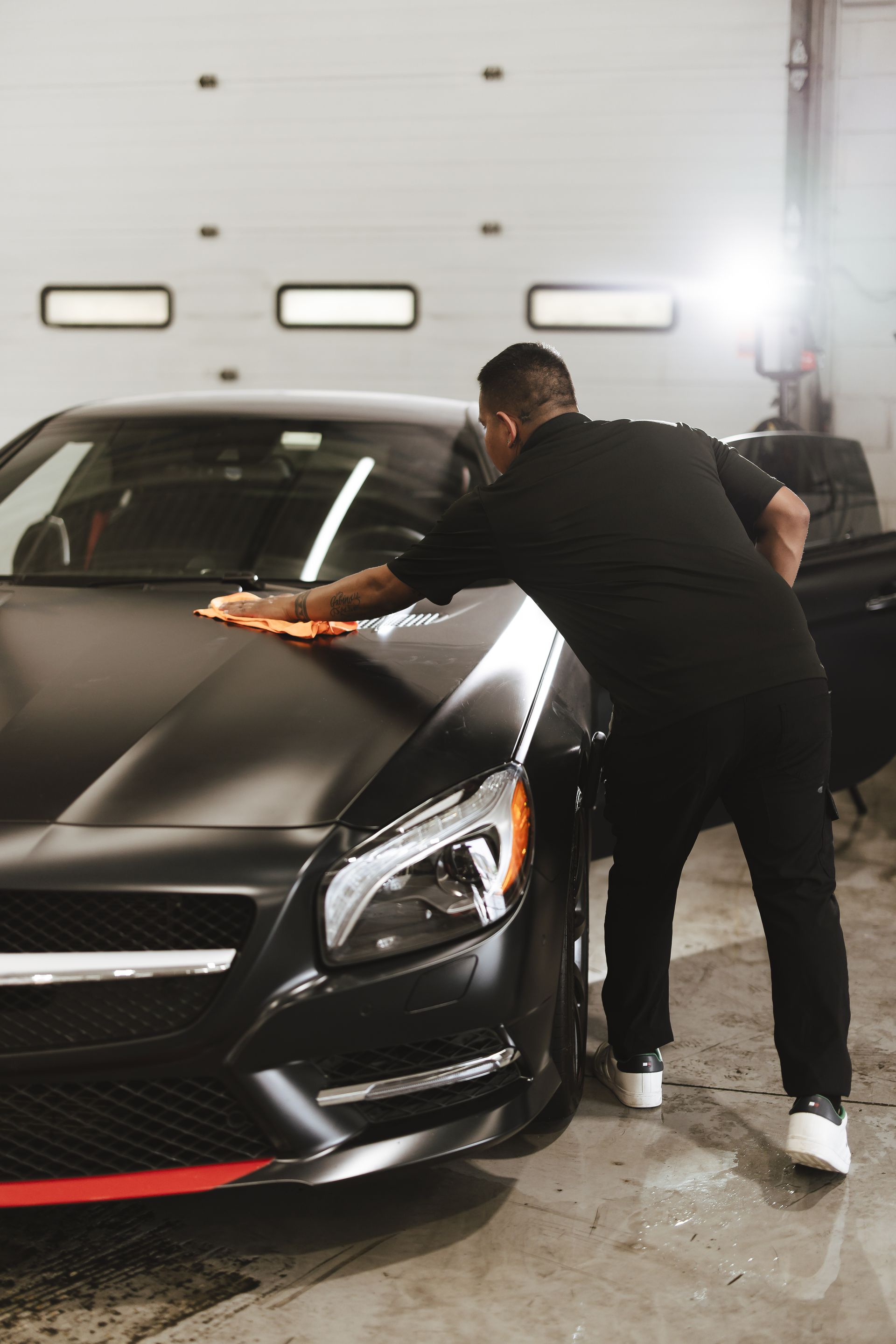 A black porsche panamera is driving down a highway.