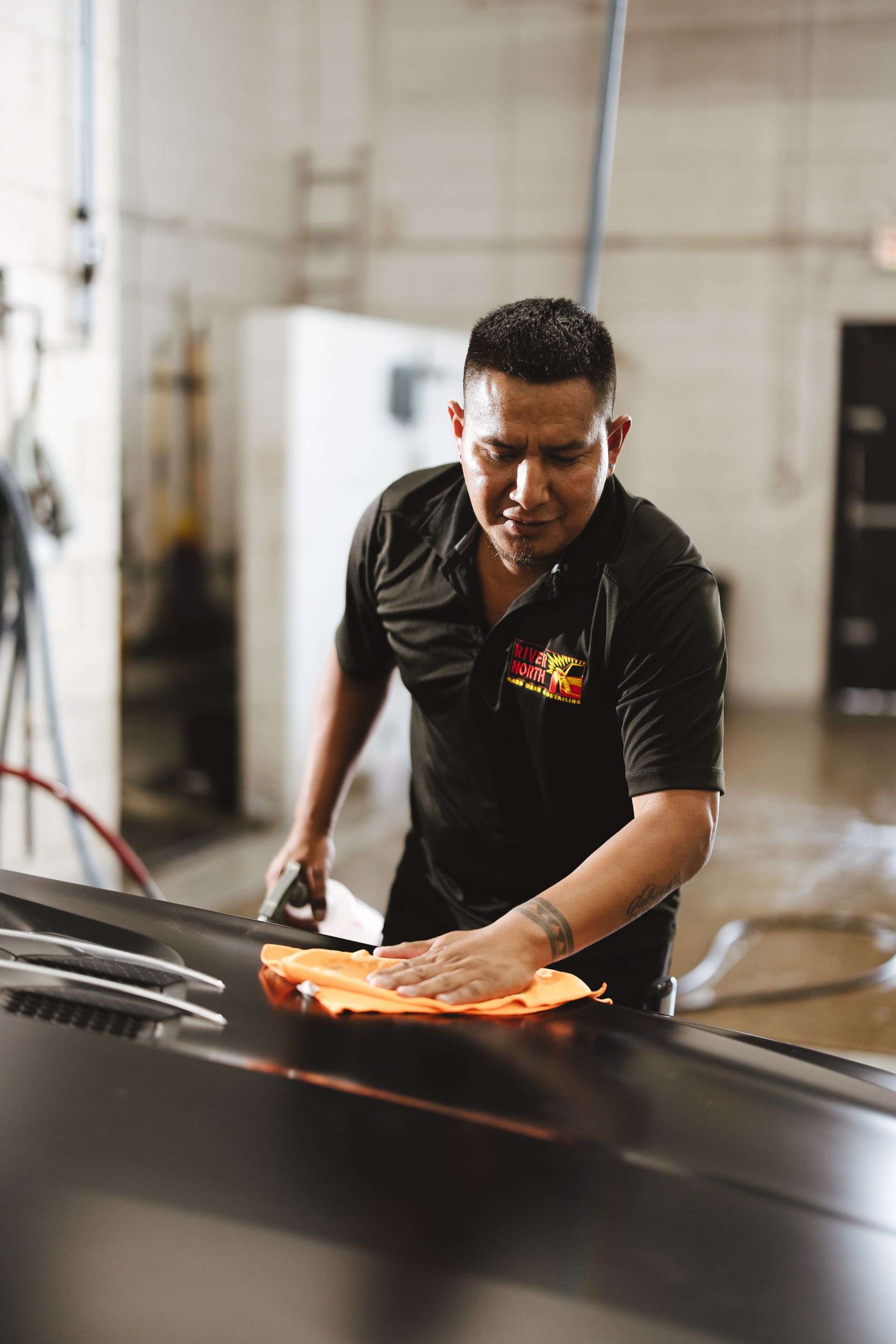 A black convertible car is parked in front of a building