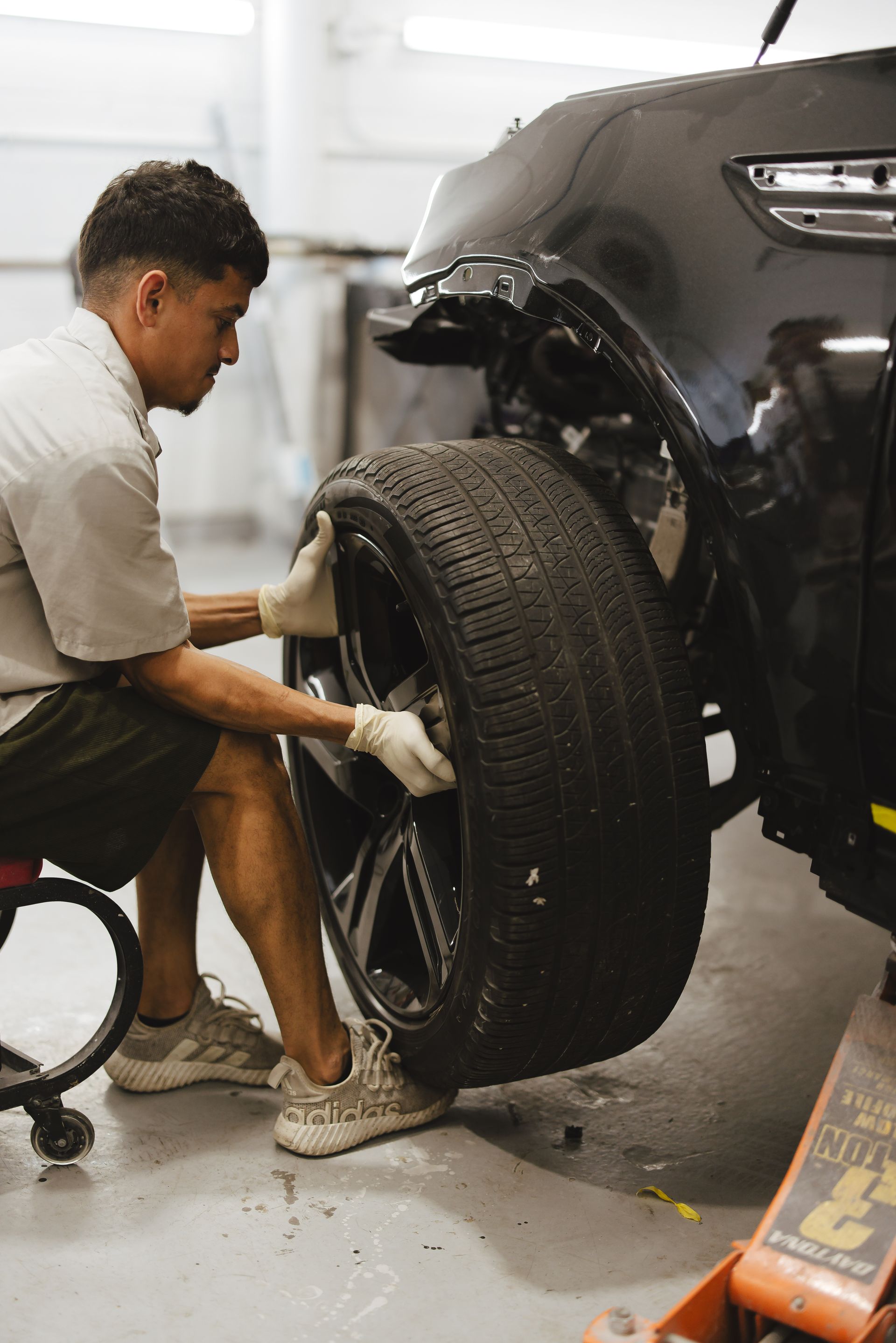 A black lamborghini aventador is parked on the side of the road.