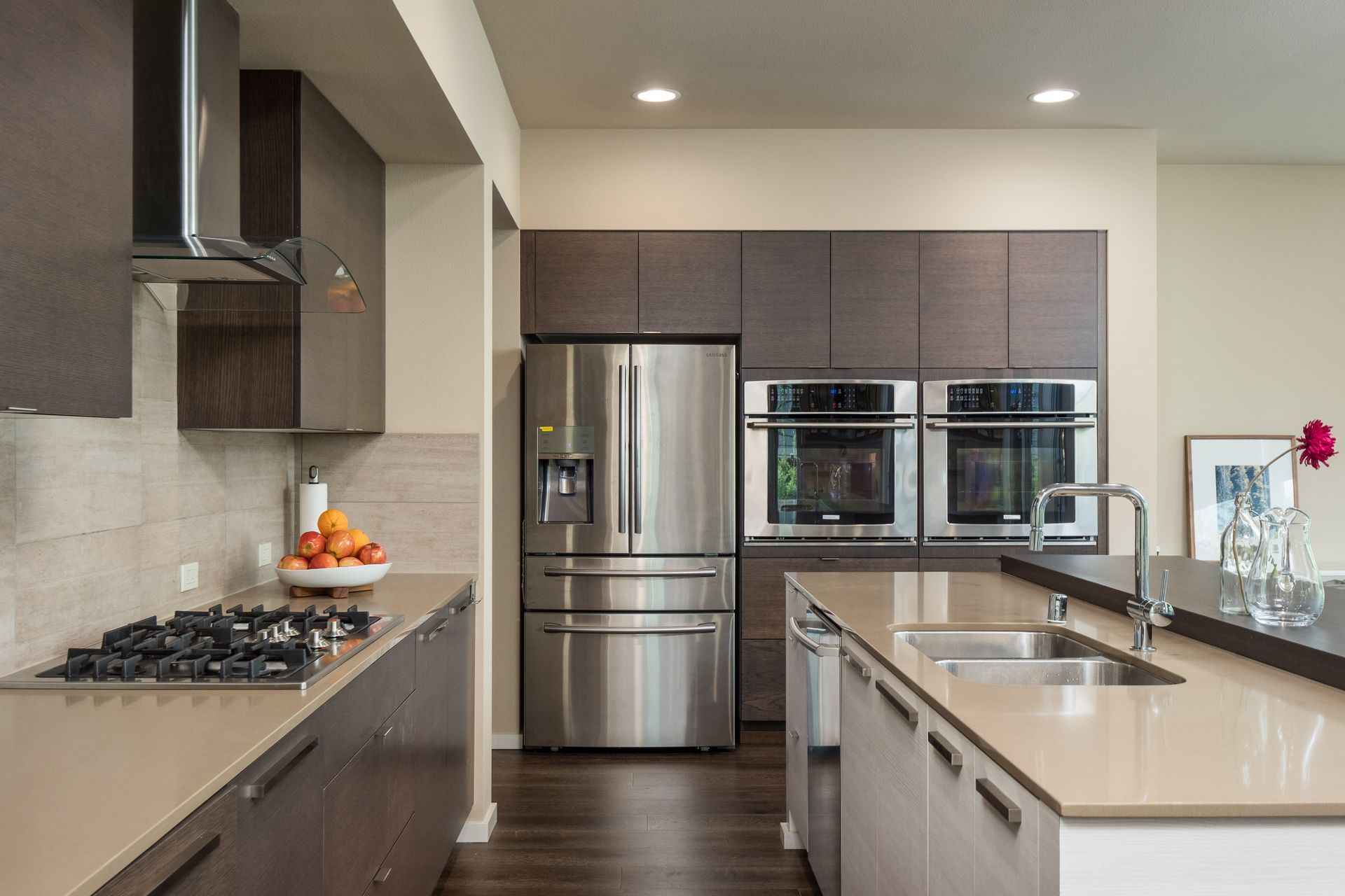 Laundry room with washer, dryer, basket of clothes, detergent, and flowers.